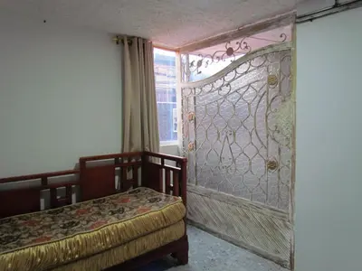 a room with two beds and a large screen door at Comodo apartamento Niquia in Bello