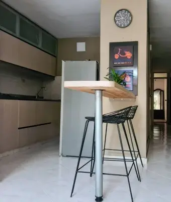 a table and a chair in a kitchen with a refrigerator at Apto 2 alcobas 2 baños 2 closet 2 camas dobles barrio cabañitas in Bello