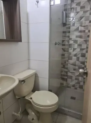 a bathroom with a toilet and a sink and a shower at Apto 2 alcobas 2 baños 2 closet 2 camas dobles barrio cabañitas in Bello
