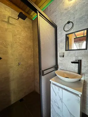 a bathroom with a sink and a shower at Glamping Mirador El Tunel in Estación El Salto