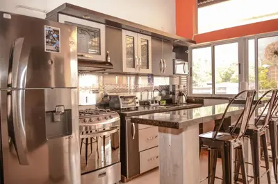 a large kitchen with a stainless steel refrigerator at Calle 10 Suites in Medellín