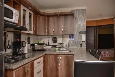 a kitchen with wooden cabinets and a counter top at Calle 10 Suites in Medellín