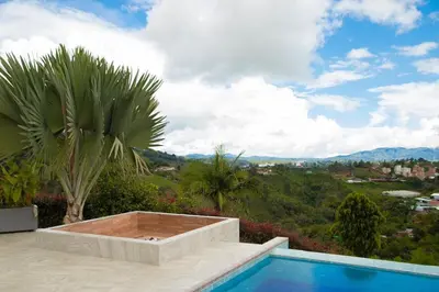 a swimming pool with a view of the mountains at Casa de Campo Monblack in El Peñol