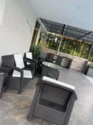 a patio with chairs and a table and chairs at Casa de Campo Monblack in El Peñol