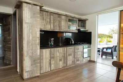 a kitchen with wood paneled walls and a counter top at Casa de Campo Monblack in El Peñol