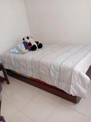 a bed with a stuffed panda bear sitting on it at Casa Piamonte in Estación El Salto