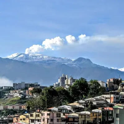 a city with snow capped mountains in the background at Casa Piamonte in Estación El Salto