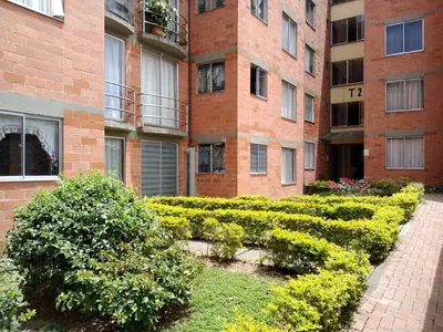a brick building with bushes in front of a building at Casa Piamonte in Estación El Salto