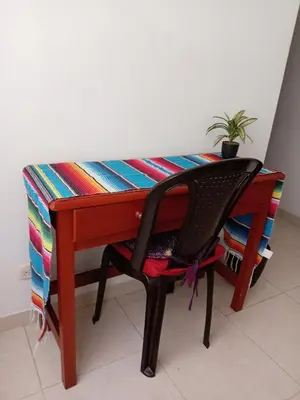 a wooden desk with a chair and a plant at Casa Piamonte in Estación El Salto