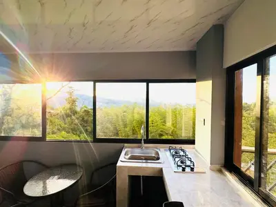 a kitchen with a sink and some windows at Hermosa Cabaña en El Peñol in Chiquinquirá