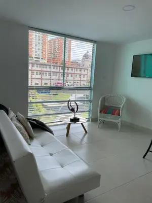 a living room with a white couch and a large window at CC Fundadores, cerca sector el Cable y CC Mall Plaza in Manizales
