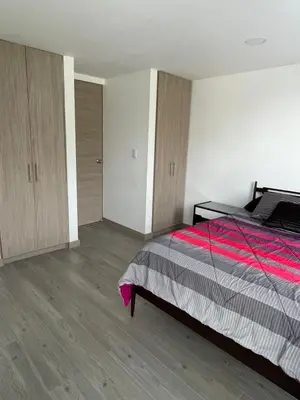 a bedroom with a bed with a red and gray blanket at CC Fundadores, cerca sector el Cable y CC Mall Plaza in Manizales