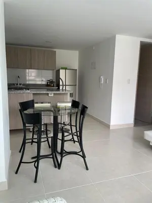 a kitchen with a table and black chairs in a room at CC Fundadores, cerca sector el Cable y CC Mall Plaza in Manizales