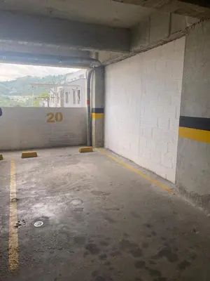 an empty parking garage with a sign on the wall at CC Fundadores, cerca sector el Cable y CC Mall Plaza in Manizales