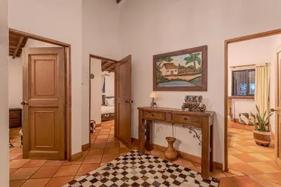 a living room with a fireplace and a painting on the wall at Country Western State in Marinilla