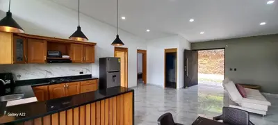 a kitchen with wooden cabinets and a counter top at Finca Villa Glamping in La Pradera