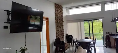 a living room with a flat screen tv on a wall at Finca Villa Glamping in La Pradera