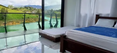 a bedroom with a bed and a view of a river at Finca Villa Glamping in La Pradera