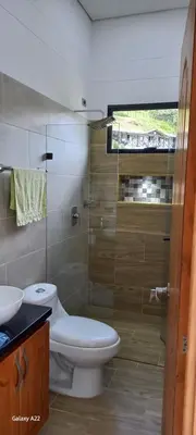 a bathroom with a toilet and a sink and a shower at Finca Villa Glamping in La Pradera