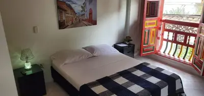 a small bedroom with a bed and a balcony at Refugio Sereno en Jericó 1 in Jericó