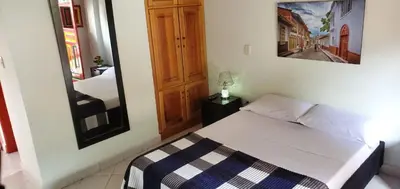 a small bedroom with a bed and a mirror at Refugio Sereno en Jericó 1 in Jericó