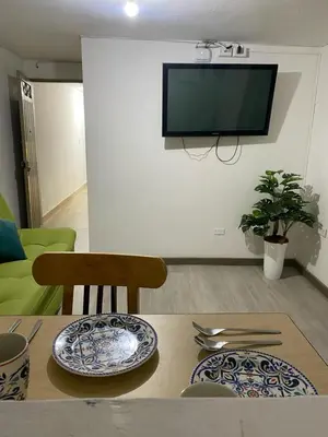 a living room with a table with plates on it at Hermoso y cómodo apartamento 4 habitaciones cerca al Viva Envigado in Envigado