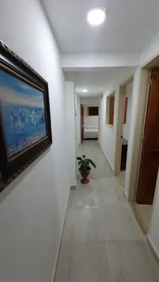 a hallway with a painting on the wall and a plant at Villa Andrea Apartamento de lujo en Jericó Antioquia para 7 personas in Jericó