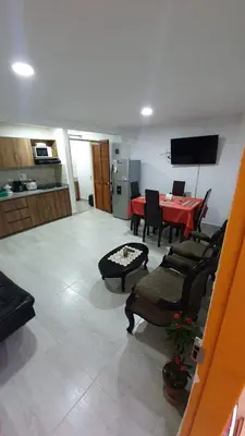 a living room with a red table and chairs at Villa Andrea Apartamento de lujo en Jericó Antioquia para 7 personas in Jericó