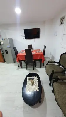 a room with a table with chairs and a red table cloth at Villa Andrea Apartamento de lujo en Jericó Antioquia para 7 personas in Jericó