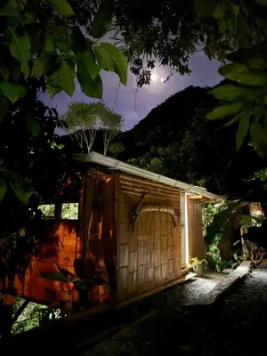 a small wooden building with a moon in the background at Casa Borojó, Refugio Natural Jacaranda in Cocorná