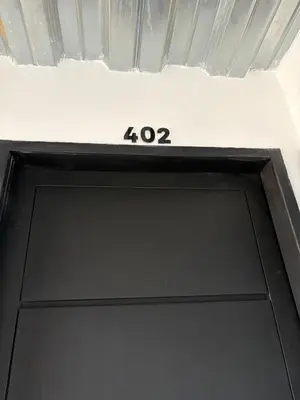 a sign above a door with the number at New apartment in Belén in Medellín