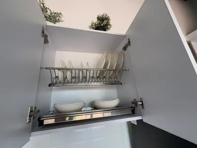 a kitchen with plates and bowls on a shelf at New apartment in Belén in Medellín