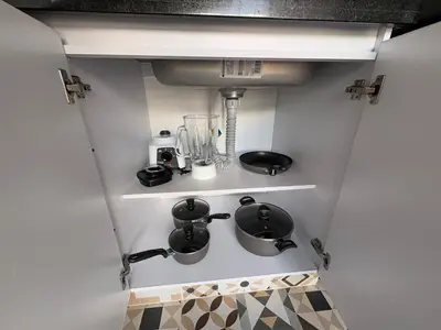 a kitchen with a stove and some pots and pans at New apartment in Belén in Medellín