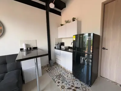 a kitchen with a black refrigerator and a counter at New apartment in Belén in Medellín