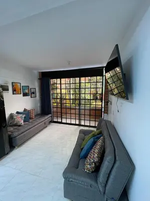 a living room with a couch and a large window at Premium Location Comfort in Medellín