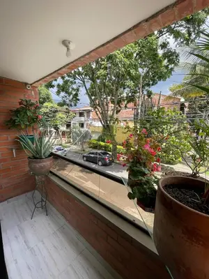 a balcony with potted plants and a view of a street at Premium Location Comfort in Medellín