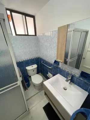 a bathroom with a white toilet and a sink at Premium Location Comfort in Medellín