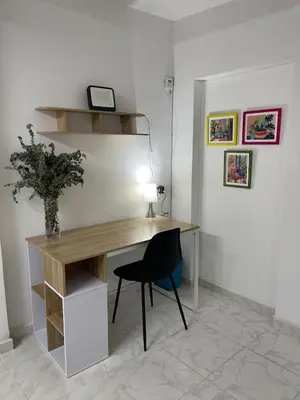a desk with a chair and a lamp in a room at Premium Location Comfort in Medellín