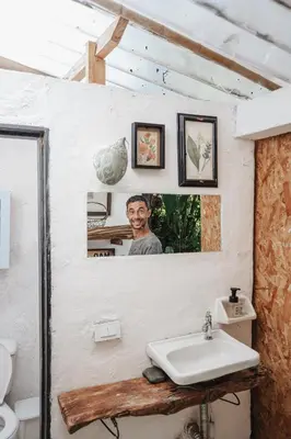 a bathroom with a sink and a picture of a man at Casa blanca, Refugio Natural Jacaranda in Cocorná