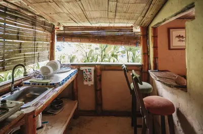 a small kitchen with a sink and a window at Casa Azúl, Refugio Natural Jacaranda in Cocorná