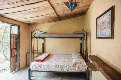 a bedroom with two bunk beds in a room at Casa Azúl, Refugio Natural Jacaranda in Cocorná