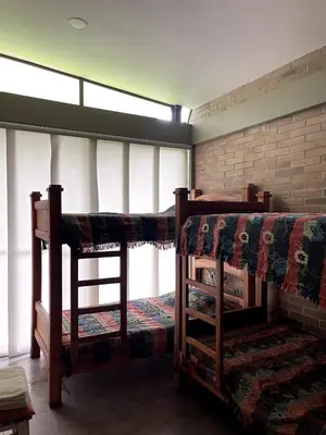 two bunk beds in a room with windows at Casa de Campo in Manizales