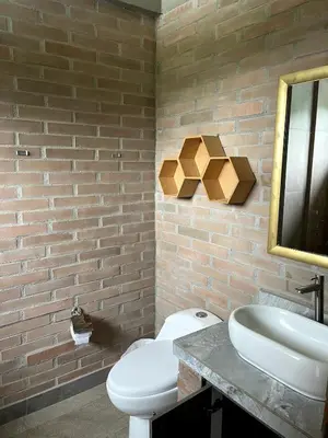 a bathroom with a white toilet and a sink at Casa de Campo in Manizales