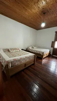 a bedroom with two beds and a wooden ceiling at El Balcón de Emma in Jardin
