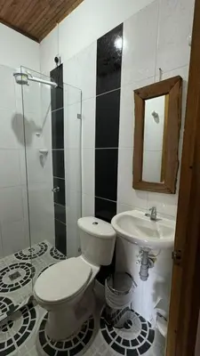a bathroom with a toilet and a sink and a mirror at El Balcón de Emma in Jardin