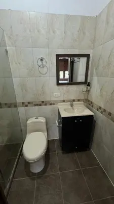 a bathroom with a toilet and a sink and a mirror at El Balcón de Emma in Jardin