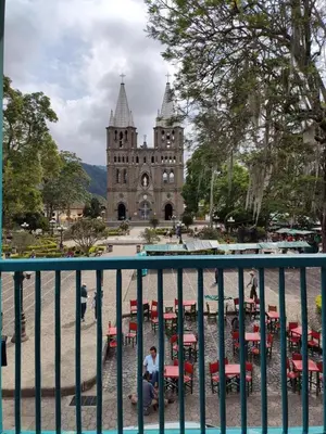 a building with tables and chairs in front of it at El Balcón de Emma in Jardin