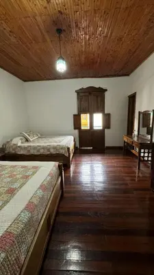 a room with two beds and a wooden ceiling at El Balcón de Emma in Jardin