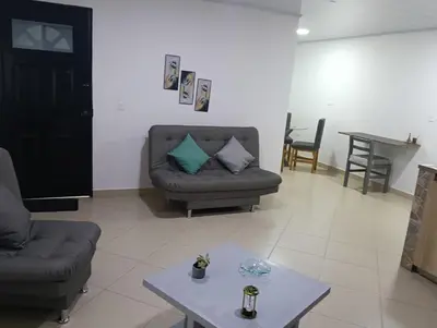 a living room with two couches and a table at Hospedaje samfer in Envigado
