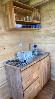 a kitchen with a sink and a stove in a cabin at Hermoso chalet en marinilla in Marinilla